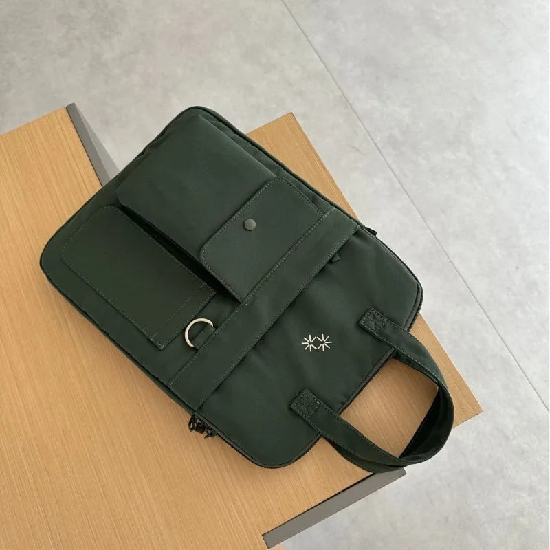 Large-capacity 13-inch laptop bag for men and women commuting business trip shoulder slung handbag.